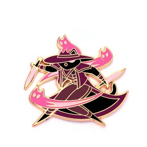 May include: Enamel pin featuring a witch character in a hat and cloak, holding a dagger. The pin has a gold outline with pink and purple accents, and pink cat-shaped flames. The witch is in a dynamic pose.