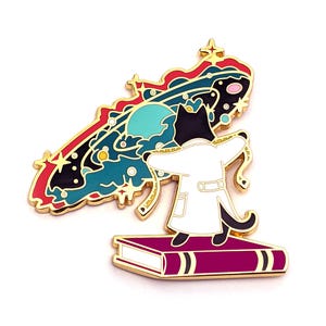 May include: A black cat wearing a white lab coat stands on a closed book, holding a swirling galaxy with stars and planets in its paws. The galaxy is a vibrant mix of red, blue, green, and black.