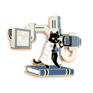 May include: A black cat wearing a white lab coat and holding a red and blue film cassette stands on a book in front of a gold-colored x-ray machine.