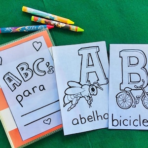 May include: A binder with the title "ABC's para" and two printable flashcards. The first card features the letter A and a bee with the word "abelha" below. The second card features the letter B and a bicycle with the word "bicicleta" below.