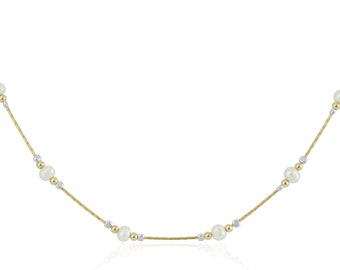 May include: A gold chain necklace with white pearls. The chain is made of two-toned gold, with a yellow gold chain and white gold beads.