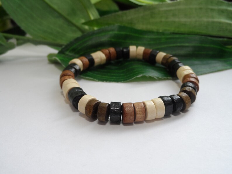 May include: A wooden bracelet with black, brown, and white beads.