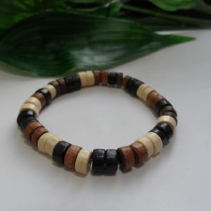 May include: A wooden bracelet with black, brown, and white beads.