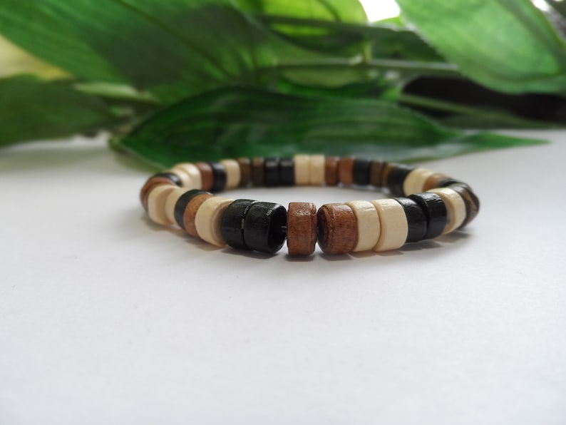 May include: A wooden bracelet with black, brown, and white beads.
