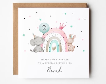 May include: A birthday card with a watercolour illustration of an elephant holding a balloon with the number 2, a rainbow, and a bunny. The card reads "Happy 2nd Birthday to a Special Little Girl" and includes the name "Norah".
