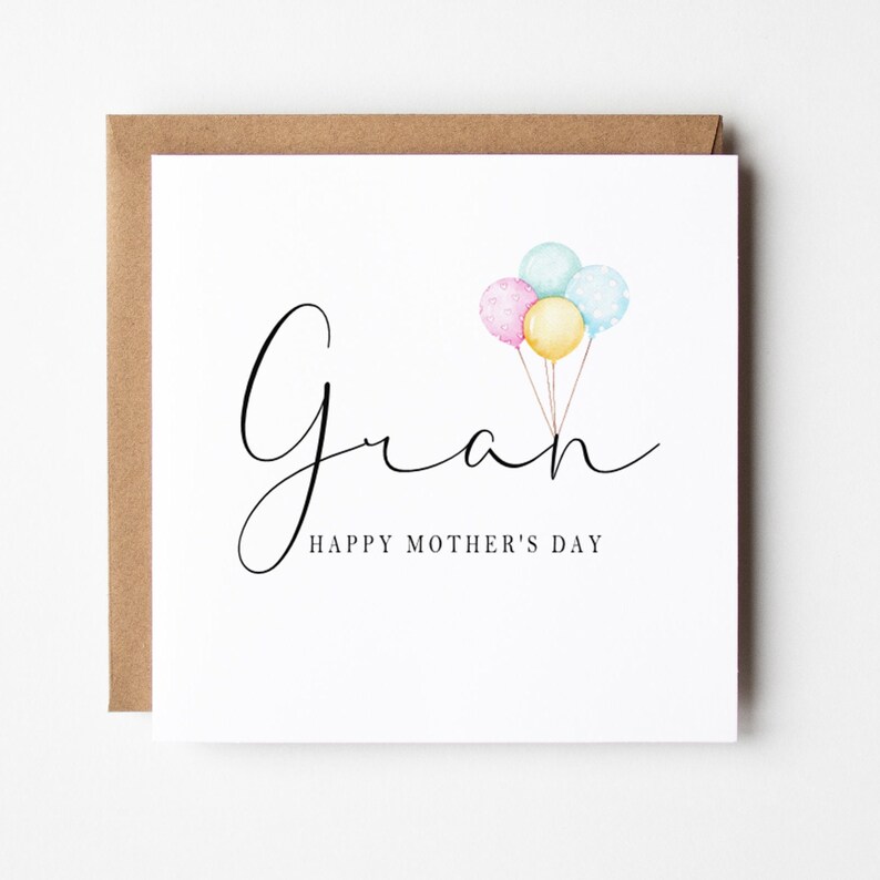 May include: A white card with the word "Gran" written in black cursive script. Three watercolor balloons in pink, blue, and yellow are floating above the word. The text "Happy Mother's Day" is written below the word "Gran".