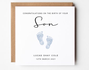 May include: Congratulations on the birth of your son, Lucas Shay Cole, born on March 12th, 2021. A white card with black text and blue watercolor footprints.