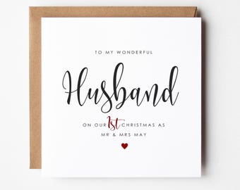 May include: A white card with black text that reads "To my wonderful Husband on our 1st Christmas as Mr & Mrs May" with a small red heart.