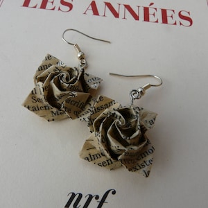 Literary pink origami earrings on book paper