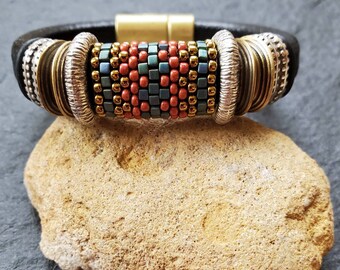 black thick leather bracelet; stripe peyote stitch bead bracelet; red + teal green+ brass bead bracelet; sterling silver and brass bracelet