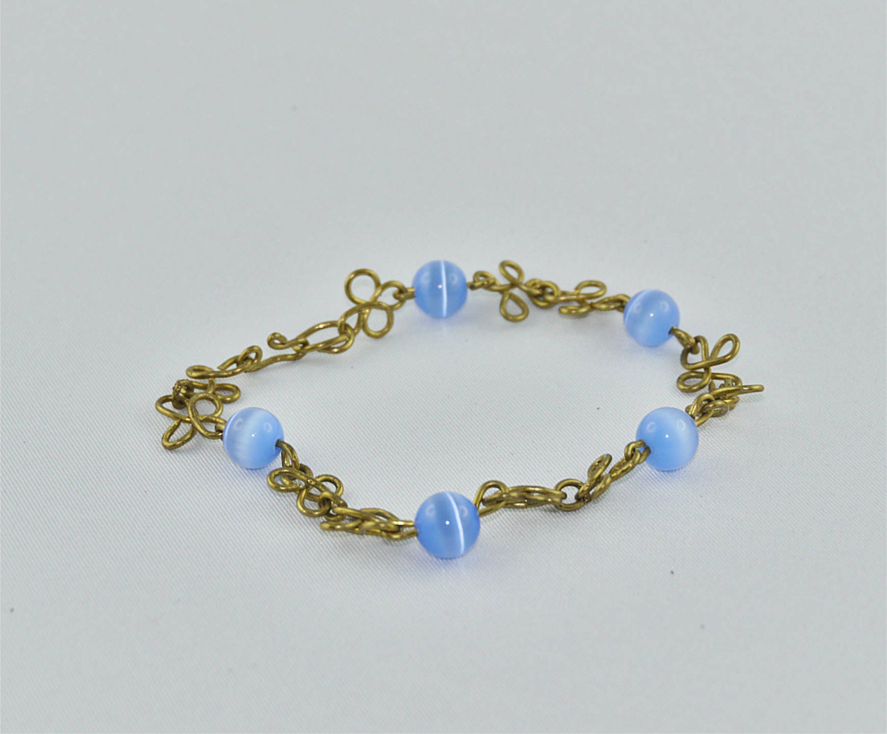 BRACELET BRASS Wire Wrapping Flowers and Blue Cat's Eye Glass