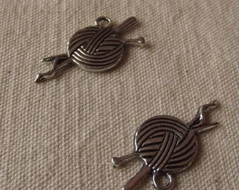 2 charms ball of yarn and knitting needles