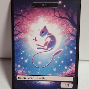 May include: A fantasy card featuring a light purple creature with blue eyes and a long tail, floating in front of a full moon. The card has the word "RAT" at the top and "Token Creature - Rat" at the bottom. The background is a pink and blue landscape with cherry blossoms and butterflies.