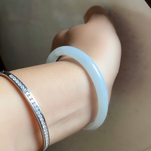100% Grade A oval white jadeite bangle 53.4 by 47 mm