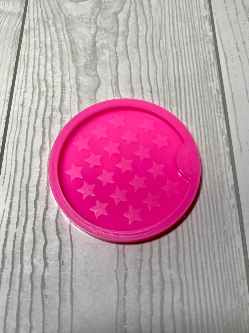 May include: Pink silicone coaster mold with a design of multiple stars.