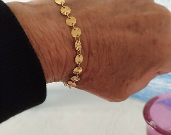 golden chain bracelet with small medals