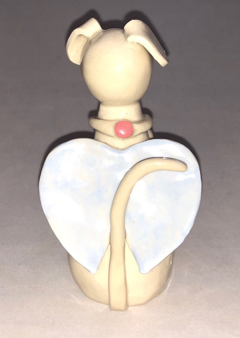 Dog angel with pink flower collar shaped Hand sculpted glazed. kiln fired to cone 6 and signed by the artist