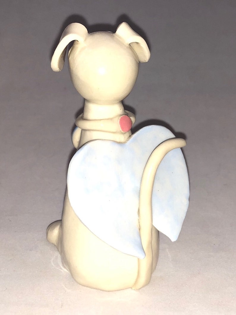 Dog angel with pink flower collar shaped Hand sculpted glazed. kiln fired to cone 6 and signed by the artist