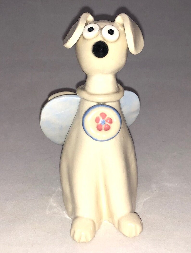 Dog angel with pink flower collar shaped Hand sculpted glazed. kiln fired to cone 6 and signed by the artist