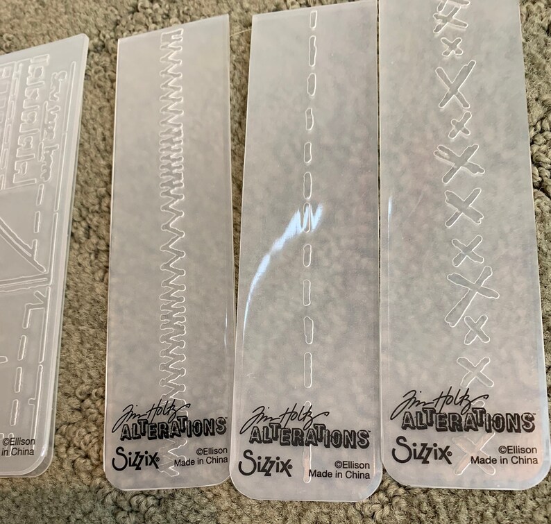 set of four Tim Holtz Sizzix Alterations Embossing Folders