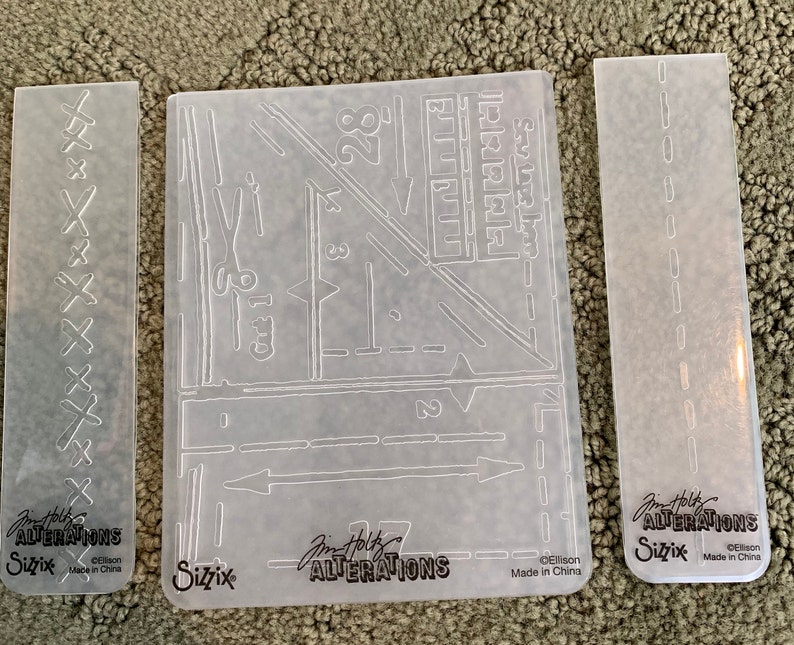 set of four Tim Holtz Sizzix Alterations Embossing Folders