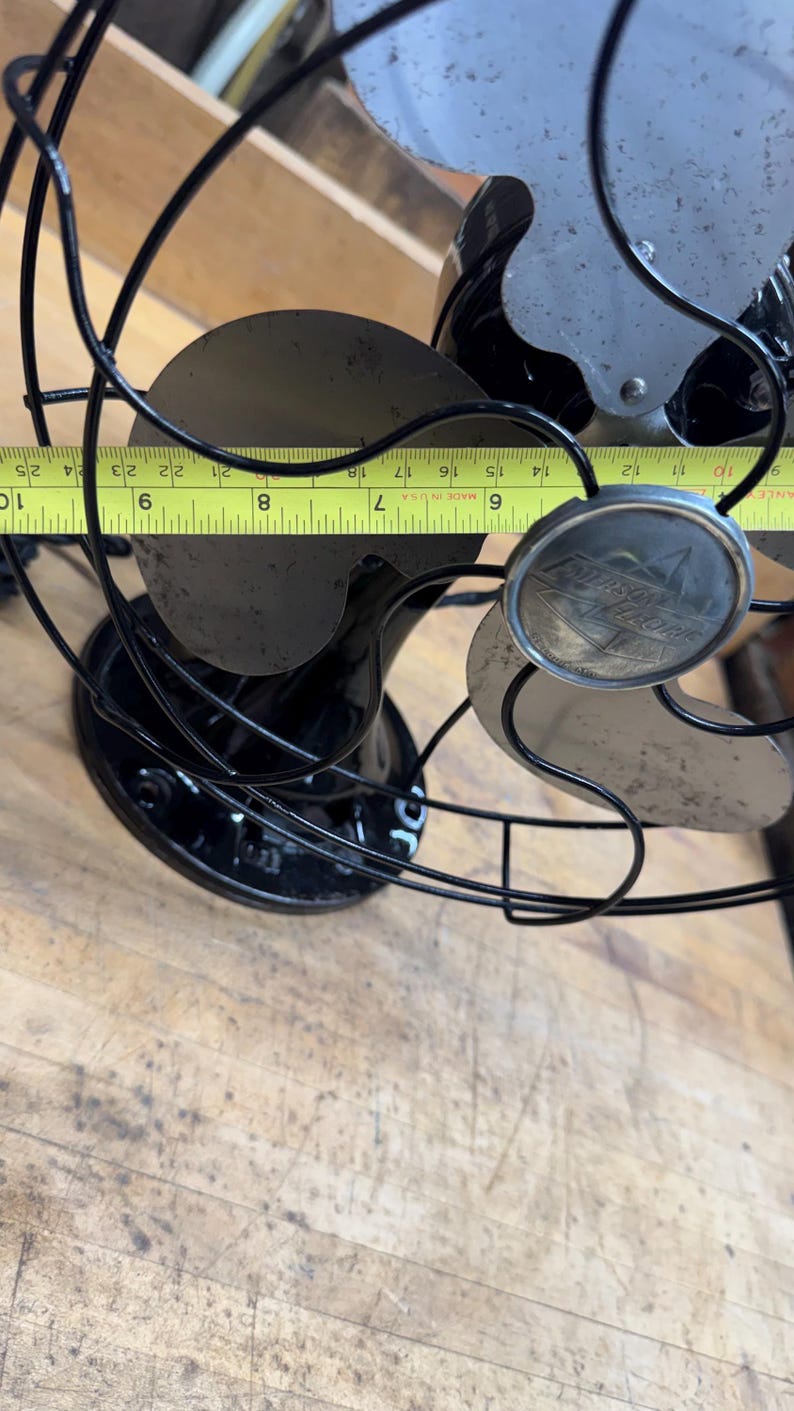 May include: Vintage black electric fan with a silver fan blade and a black cage. The fan's blade span measures approximately 8 inches. The fan has a round emblem with the text "Polaris Electric".