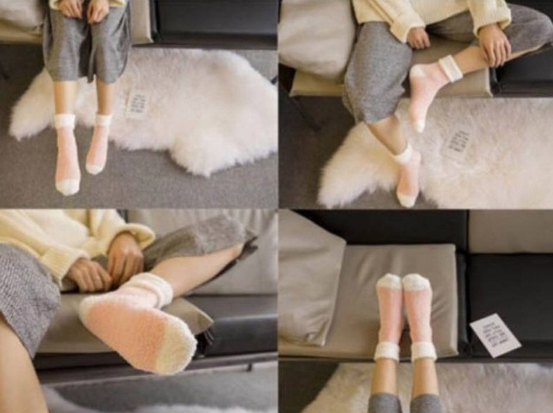 May include: A pair of fuzzy pink and white socks with a white cuff. The socks are worn by a person sitting on a couch.