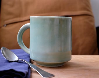 Handmade, ceramic coffee mug or teacup with celadon green glaze.