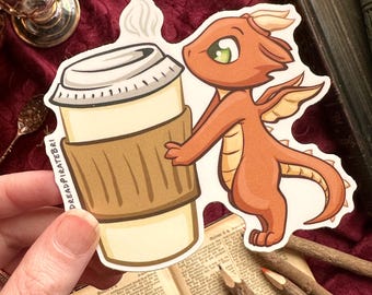 May include: A die-cut sticker featuring a small orange dragon with cream-colored horns and underbelly, holding a large beige coffee cup with a brown sleeve and a white lid. The text DREADPIRATEBRI is printed vertically along the side of the cup.