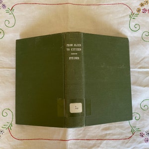 May include: A green hardcover book with the title "From Alien to Citizen" and the author's name "Steiner" printed in white on the front cover.