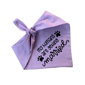 May include: A lavender dog bandana with black paw prints and the text "My humans are getting married".