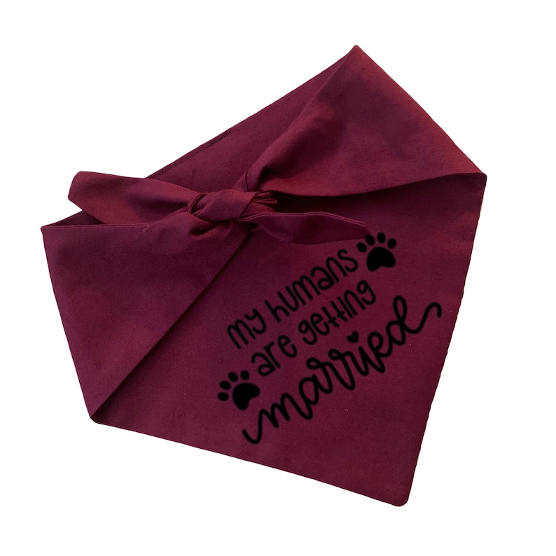 May include: Burgundy dog bandana with black paw prints and the text "My humans are getting married".
