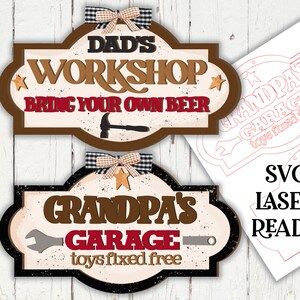 May include: Two laser cut wooden signs with a rustic theme. The top sign is brown with white text that reads "Dad's Workshop Bring Your Own Beer". The bottom sign is black with white text that reads "Grandpa's Garage Toys Fixed Free".