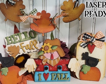 May include: A set of fall-themed wooden cutouts, including a scarecrow, pumpkins, a bird, and a banner that says "Hello Fall". The cutouts are painted in warm colors and have a whimsical style. The text "SVG LASER READY" is visible in the top right corner of the image.