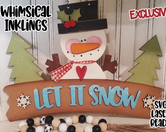 May include: A wooden sign with a snowman and two trees on either side. The sign says "Let It Snow" in blue lettering with a snowflake on the left and right. The sign is labeled "Whimsical Inkling" and "Exclusive!" and "SVG Laser Ready".