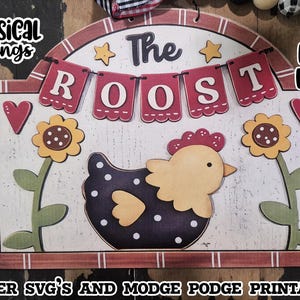 Peut inclure: Une enseigne en bois rectangulaire avec un sommet arqué représentant un poulet bleu foncé à pois blancs, deux tournesols jaunes et deux cœurs rouges. Le texte "The ROOST" est affiché sur une bannière, avec les mots "WHIMSICAL INKLINGS" et "SVG LASER READY".