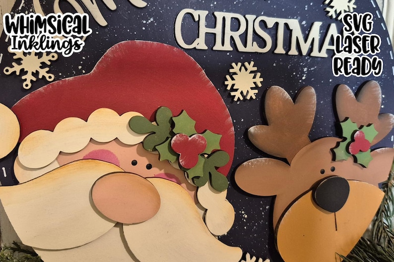 May include: A wooden Christmas decoration featuring Santa Claus and a reindeer, with the word "CHRISTMAS" in large letters. The design includes snowflakes and the text "SVG Laser Ready" and "Whimsical Inklings".