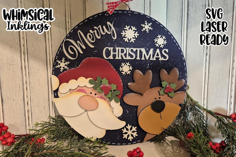 May include: A round, navy blue Christmas sign featuring Santa Claus and a reindeer. The sign has the words "Merry Christmas" and snowflake cutouts. The sign is decorated with greenery and red berries. The text "SVG Laser Ready" is also visible.