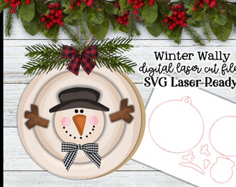 May include: A digital laser cut file for a winter-themed wall decor featuring a snowman with a black hat, brown stick arms, and a black and white checkered bow. The file is labeled "Winter Wally digital laser cut file SVG Laser-Ready".