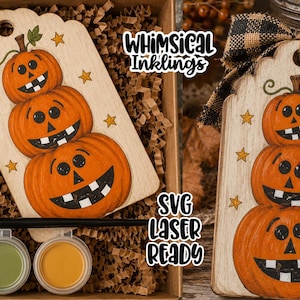 May include: A wooden tag featuring a stack of three orange jack-o'-lanterns with black faces and yellow stars, accompanied by a paintbrush and four small paint pots. The text "Whimsical Inklings" and "SVG LASER READY" is visible.