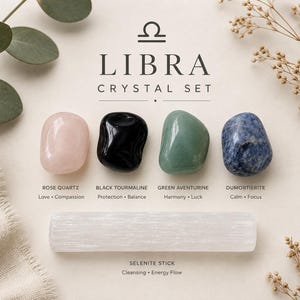 May include: A Libra crystal set featuring four polished stones: a pale pink rose quartz, a glossy black tourmaline, a smooth green aventurine, and a mottled blue dumortierite. Below them lies a long, white, fibrous selenite stick.
