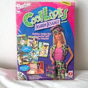 May include: A Barbie Cool Looks Fashion Designer CD-ROM software box featuring a blonde doll wearing a green and purple patterned outfit with a matching hat and bag. The pink and blue packaging displays various character images and text.