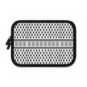 May include: Black and white laptop sleeve featuring a traditional Palestinian keffiyeh pattern. The sleeve has a zipper closure.