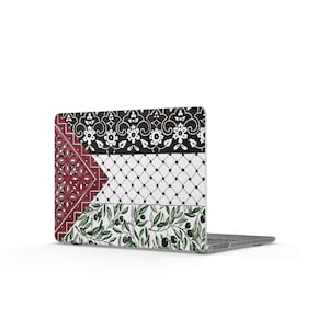 May include: A laptop case with a decorative design. It features a black and white floral pattern, a red and white geometric pattern, and olive branches with black olives. The case is set against a white backdrop.