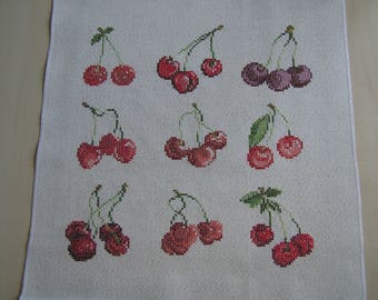 Embroidery of different varieties of cherries with cross stitch