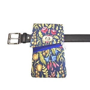 May include: A floral print belt bag with a blue zip and a silver clasp, attached to a black leather belt. The bag features a navy blue background with colourful flowers and foliage.