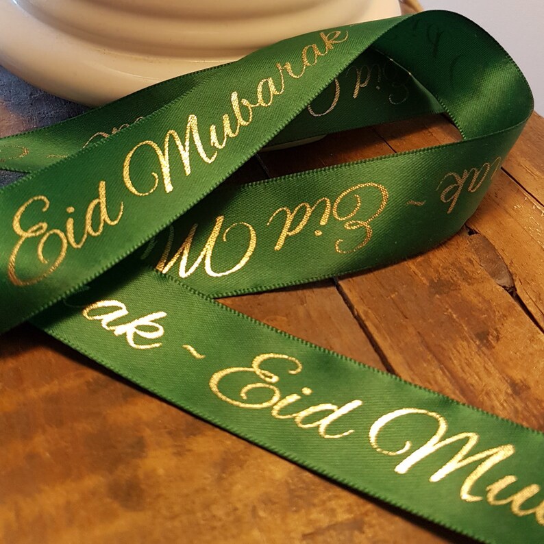 May include: Green satin ribbon with gold lettering that reads "Eid Mubarak".