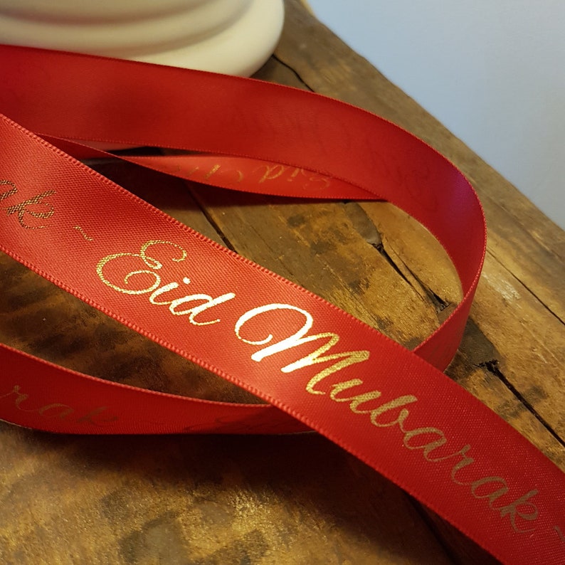 May include: Red satin ribbon with gold lettering that reads "Eid Mubarak".