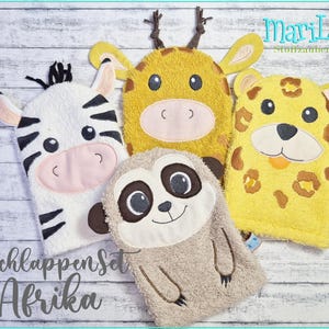 May include: A set of four animal-themed washcloths. The set includes a zebra, giraffe, leopard, and sloth. Each washcloth is a different color and features embroidered details. The text "Waschlappenset Afrika" is visible.