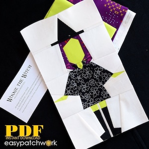 Könnte beinhalten: Ein Papierpuppenmuster für eine Hexe mit einem schwarzen Hut, grünem Gesicht, einem schwarz-weiß gemusterten Kleid und schwarzen Stiefeln. Das Muster heißt "Winnie the Witch" und ist als PDF-Sofortdownload bei easy patchwork erhältlich.